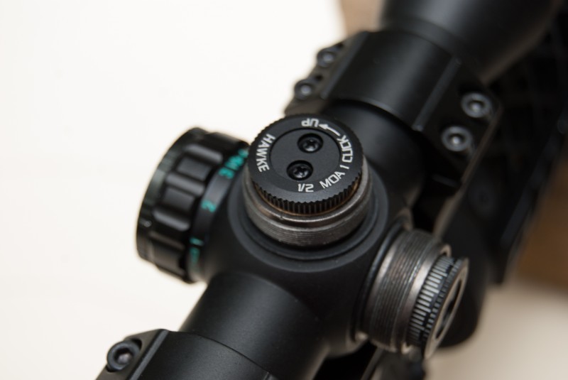The elevation direction is clearly indicated on this Hawke optics scope. Each click in the counter-clockwise direction moves the bullet impact up ½-inch at 100 yards.