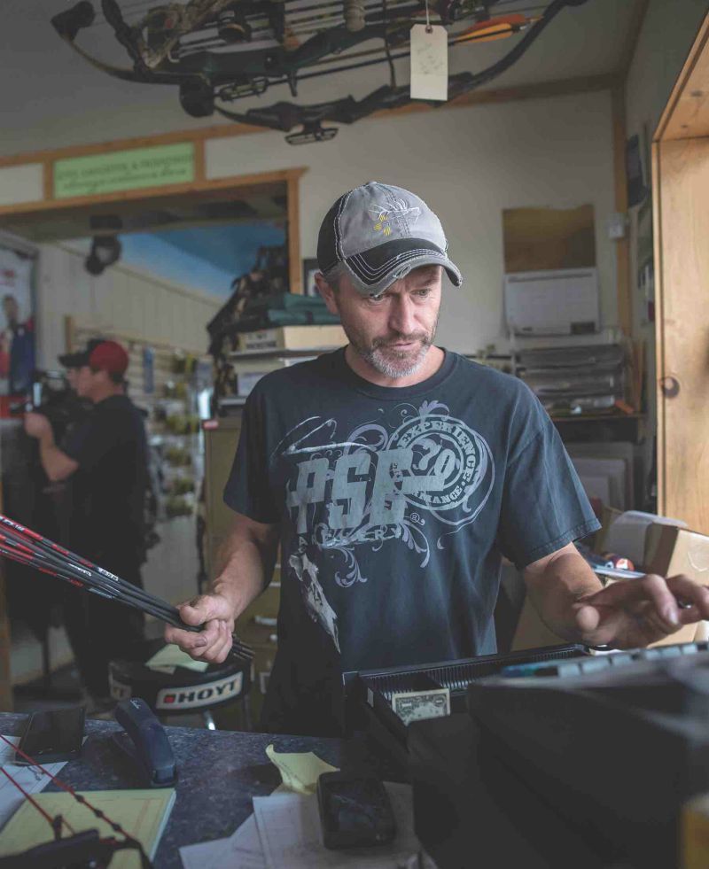 Pro shop employee on cash register