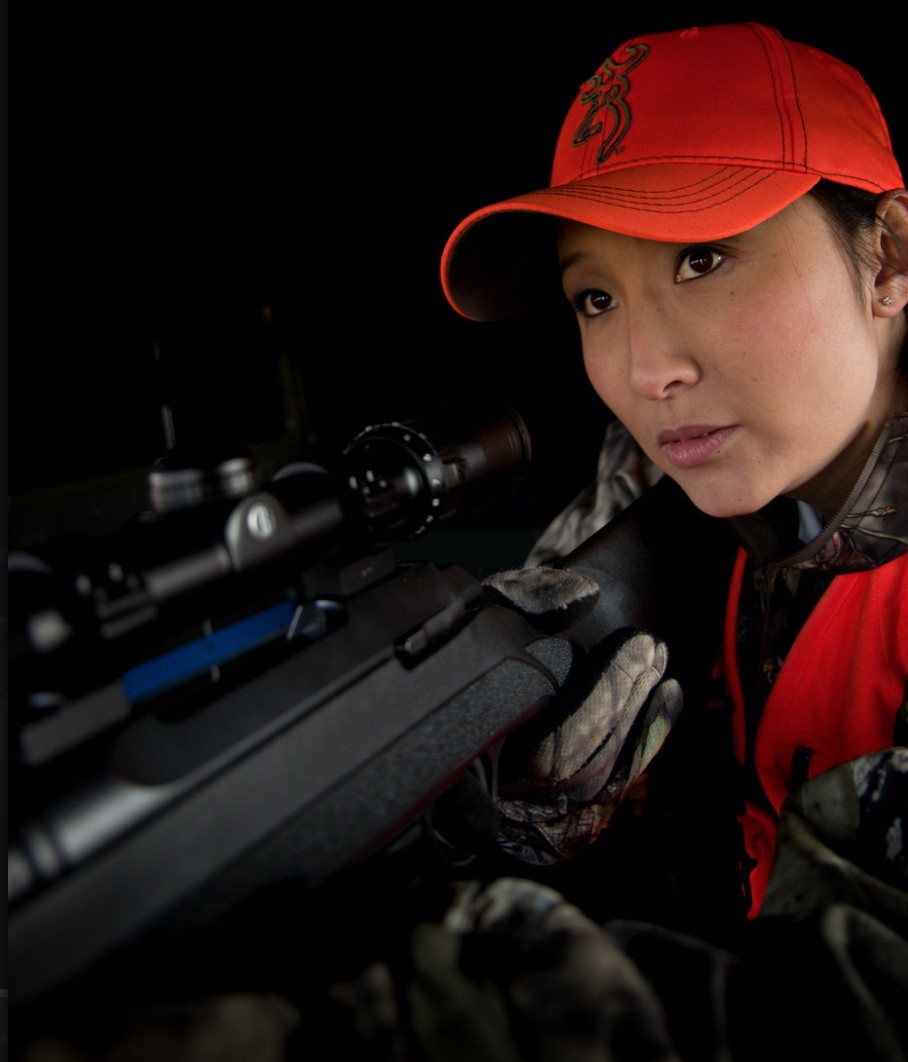 Woman ready to aim rifle