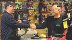 Salesman at archery shop counter e991f65cda8cad0d03a7ea8cd2674507