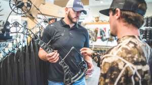 Bow shop salesman showing new bow 190423 105345