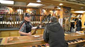 Gun salesman at counter