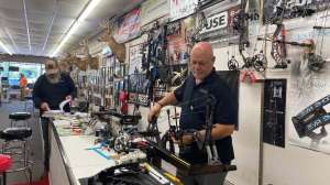 Cropped Full Draw Archery owner Ronnie Kimbrough working on a bow before the season opens