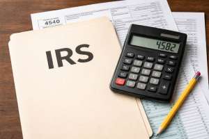 Web Tax preparation tools on wooden desk