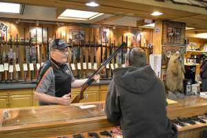 Gun salesman at counter