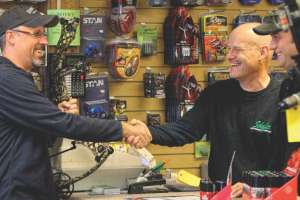 Salesman at archery shop counter
