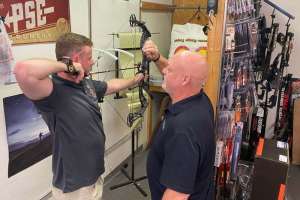 Cropped Full Draw Archery owner Ronnie Kimbrough checks the draw length and peep alignment